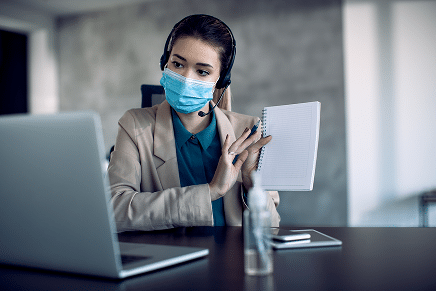 female-entrepreneur-wearing-face-mask-while-talking-video-call-office-1